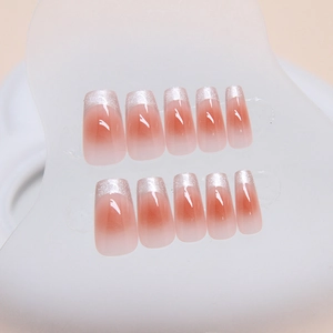 French cat-eye press-on nails with peach pink gradient and silver glitter tips