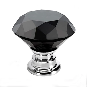 Black crystal glass furniture knob with polished silver base on white background
