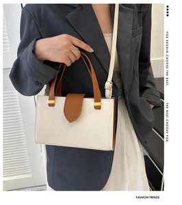 Business tote bag in white and brown leather with shoulder strap shown on a model