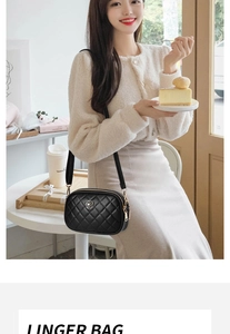 Detail of black quilted crossbody bag featuring a golden 3D rose metal logo and zippers