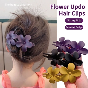 Floral matte claw clip in purple, black, and ginger yellow for elegant hairstyling