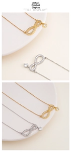 Detail of gold and silver infinity heart necklaces with micro-set cubic zirconia stones