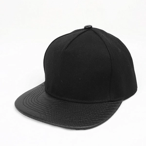 Detail view of black snapback hat showing faux crocodile leather texture on the flat brim