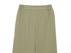 Flat lay of olive green wide-leg trousers showing elastic waist and linen texture