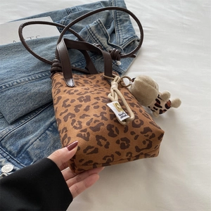 Leopard print crossbody bag with plush bear pendant and leather handles for 2024 fashion