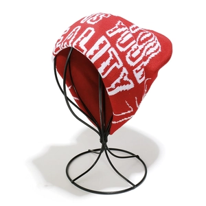 Detailed knit texture of red beanie featuring white quality and journey lettering