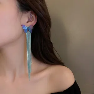Blue gradient butterfly earrings with long fringe tassels on model for women