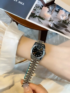 Elegant silver stainless steel watch with black dial and calendar worn on the wrist