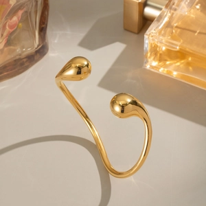 Minimalist 18K gold plated stainless steel open bangle with fluid teardrop ends