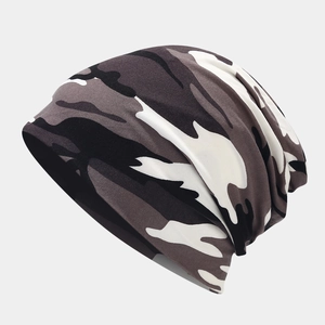 Detailed close-up of camouflage beanie showing fabric texture and slouchy knitted folds