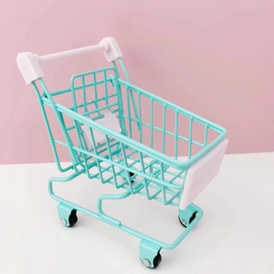 Miniature mint green metal shopping cart with white plastic handle for desk storage