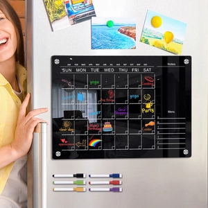 Detailed view of black magnetic acrylic weekly calendar board with six colorful markers on fridge