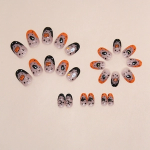 Halloween oval press-on nails set with pumpkin and ghost motifs on 24 false nail pieces
