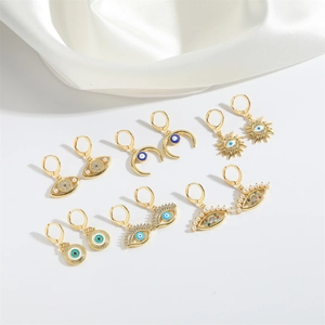 Golden Evil Eye earring set featuring blue enamel, pearls and sparkling crystals