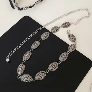 Close-up of vintage silver oval butterfly chain belt with lobster clasp and floral texture