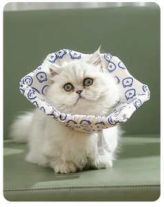 Detail view of the soft padded cat recovery collar featuring blue bear patterns on white fabric