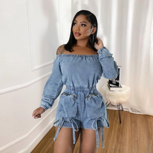 Close-up of light blue denim romper with waist-cinching design and functional large pockets