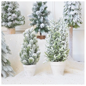 Detail view of mini flocked Christmas trees with cedar bases in various heights
