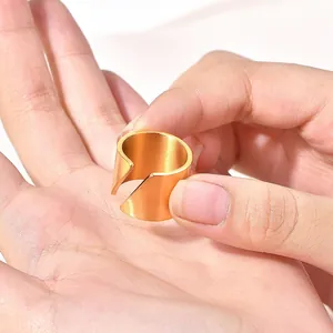 Minimalist gold stainless steel open ring with wide beveled band for women in a hand-held view