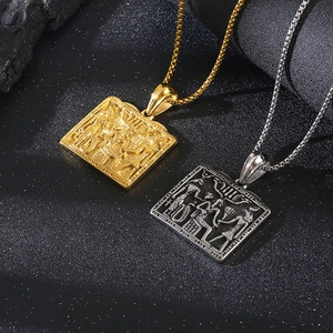 Detail of square Pharaoh pendants in gold and silver finish with Egyptian reliefs