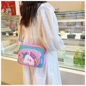 Detail of canvas crossbody bag with cartoon unicorn and rainbow strap on a model
