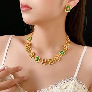 Vintage jewelry set with gold necklace and earrings featuring colorful enamel floral motifs