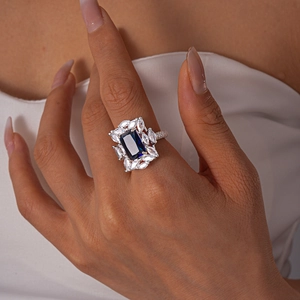 Macro detail of luxury ring featuring deep blue rectangular stone and marquise diamonds