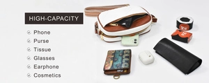 Detailed interior storage showing high capacity for phone and wallet in white and brown bag