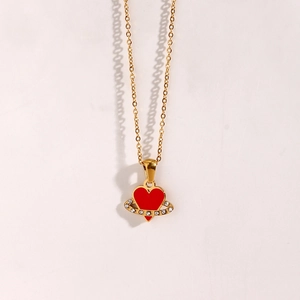 Detail of gold chain with red heart planet pendant and sparkling zircon accents
