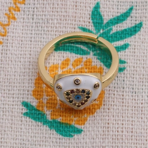 Macro shot of gold Evil Eye open ring with colorful zircon and white enamel detail