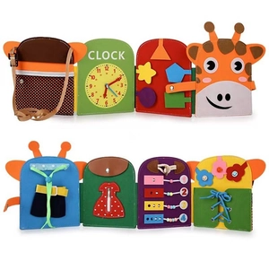 Detail view of felt busy board featuring a clock, zipper, and color matching puzzles