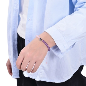 Pink and purple beaded bracelet with heart projection pendant on female model wrist