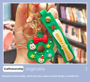 Detail of green Christmas keychain with Santa charms and Merry Christmas strap