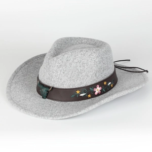 Detail of grey wool fedora with floral embroidery and bronze bull head accessory