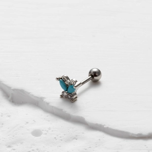 Detailed view of butterfly cartilage stud with turquoise stones and clear cubic zirconia