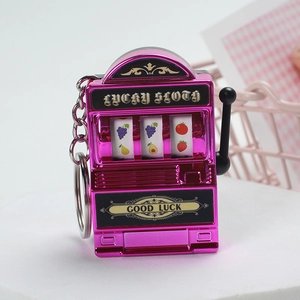 Close-up of a rose red mini slot machine keychain with a lucky sloth design