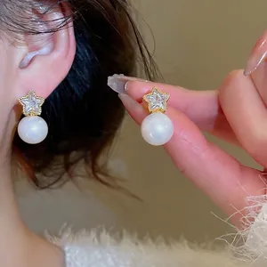 Elegant gold plated star stud earrings with sparkling zircon and round white pearls