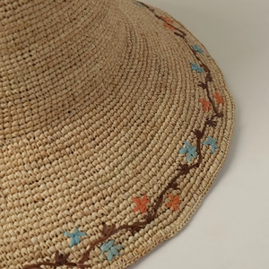 Handmade raffia straw hat with elegant floral embroidery and wide brim for sun protection