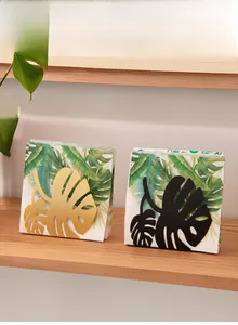 Detail of Nordic monstera leaf napkin holder in matte gold and black metal finish