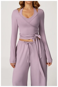 Detail of lavender wrap-style yoga top with side ties and high-waist wide-leg pants