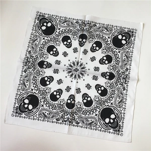 White cotton bandana with black skull and paisley print in flat lay top view