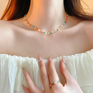 3-piece colorful seed bead necklace and ring set in orange, green, and cream white