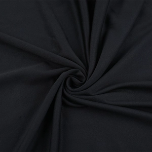 Close-up of black evening dress fabric showing fine texture and elegant pleated drape