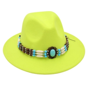 Detail of neon yellow fedora hat featuring ethnic turquoise beads and wooden ornaments
