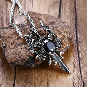 Retro stainless steel dragon sword necklace with black gemstone inlay on stone background