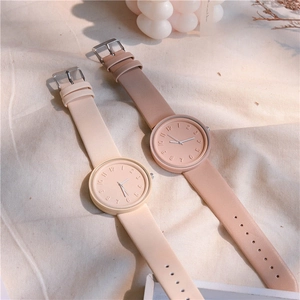 Minimalist Nordic quartz watches in beige and soft pink colors on a fabric backdrop