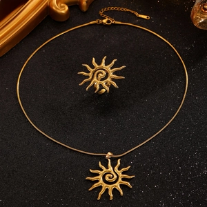 Detail of 18k gold plated stainless steel sun pendant necklace and matching ring set