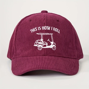 Detail of white embroidery with golf cart text on dark burgundy corduroy baseball cap