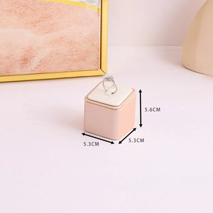 Detail view of pink PU leather ring display stand with dimensions 5.6cm by 5.3cm