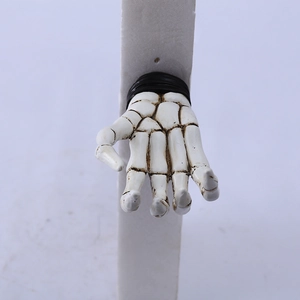 Detailed view of a white 3D skeleton hand wall hook with vintage black textures and strap